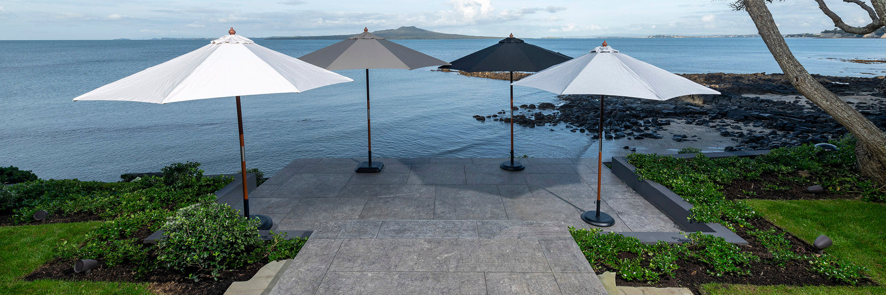 A collection of premium outdoor umbrellas from Design Warehouse, elegantly arranged to provide shade and style for patios and outdoor spaces.