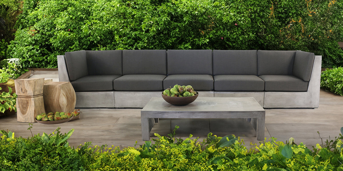 Box concrete modular garden furniture collection situated on exterior deck.