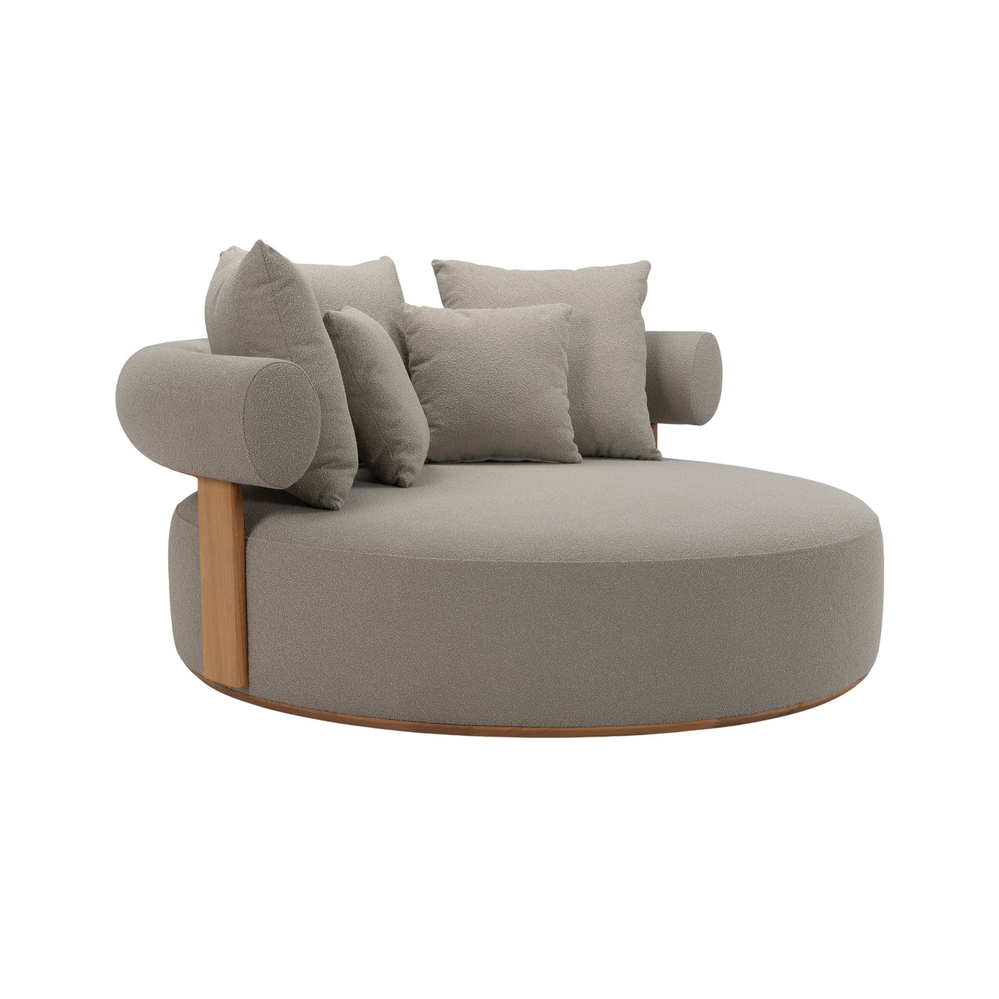 Cap Ferrat teak daybed with round, plush seating and a curved teak frame back. Front angle view showing pillows. 