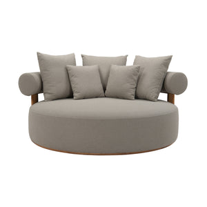 Cap Ferrat teak daybed with deep plush seating cushions and pillows. Curved back. Front view.