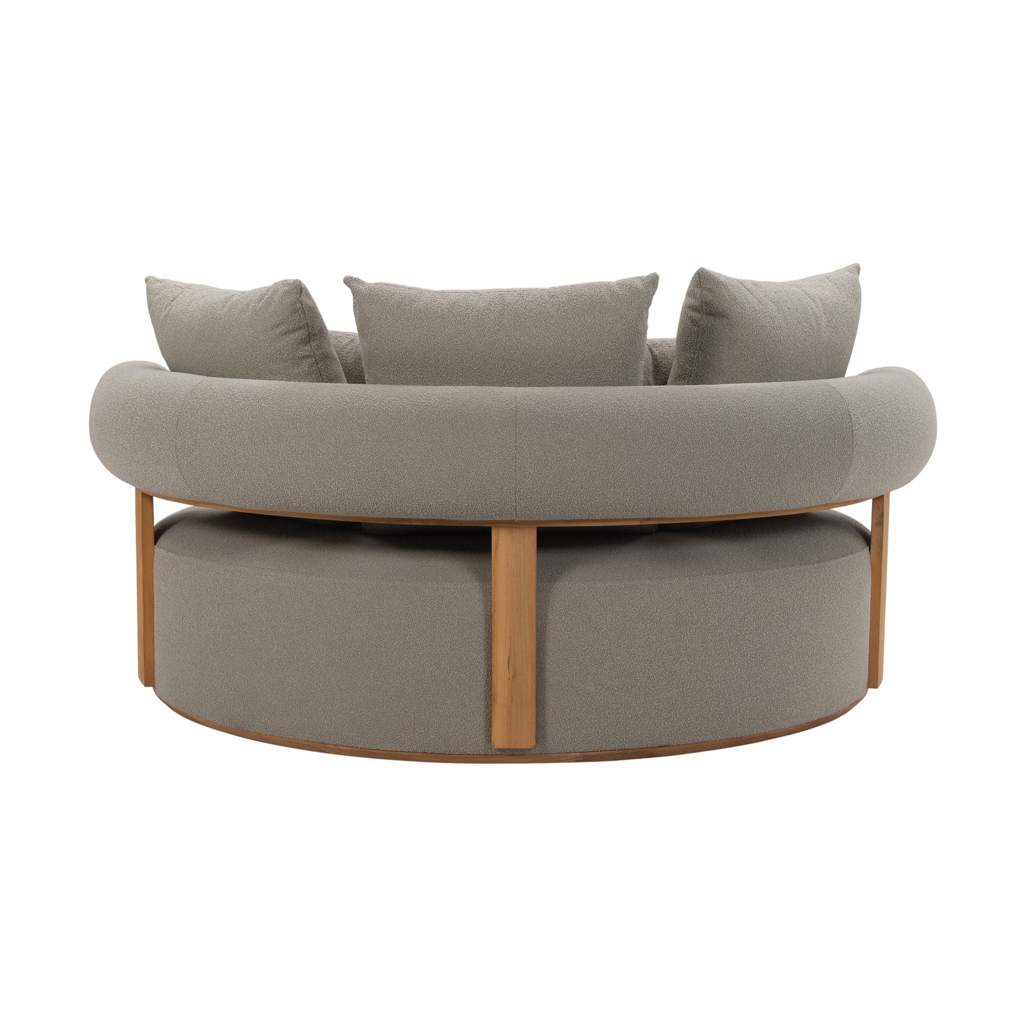 A curved Cap Ferrat teak daybed with plush cushions and pillows. Rear view.