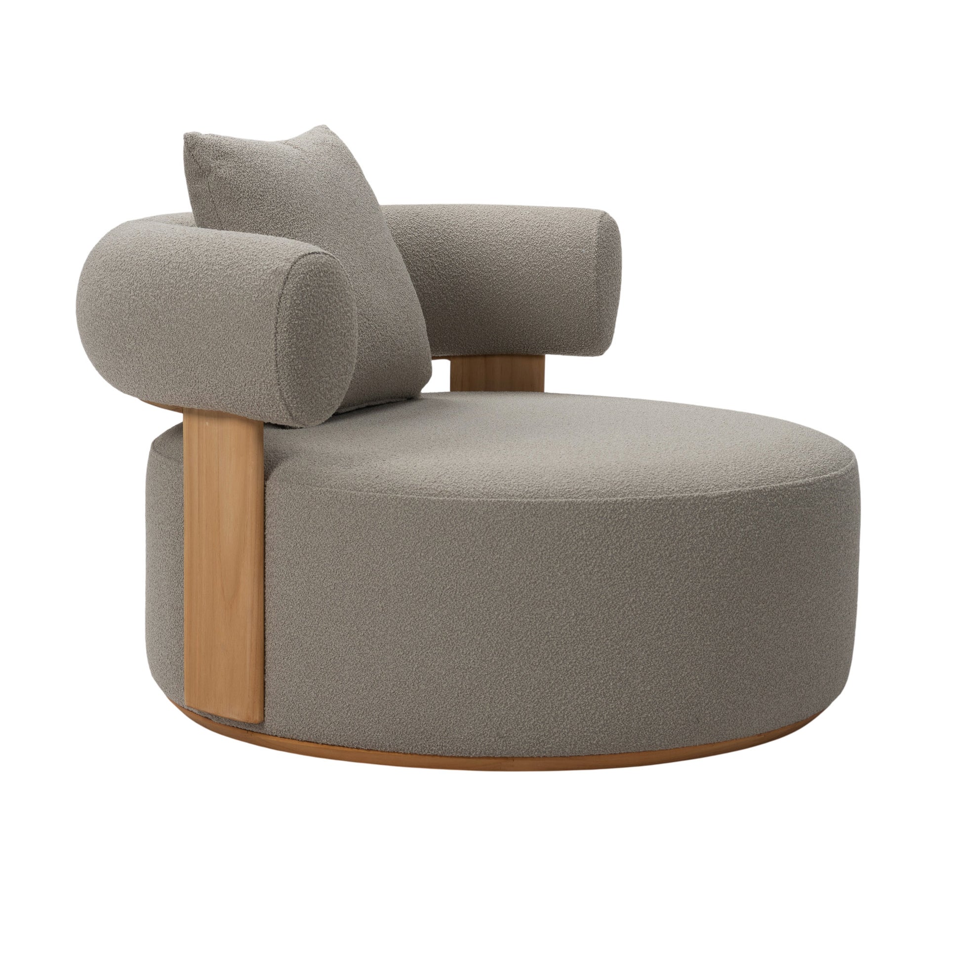 Front angle view of Cap Ferrat teak lounge chair with round seating and armrest with plush seating fabric and on back arm rest with pillow cushion. 