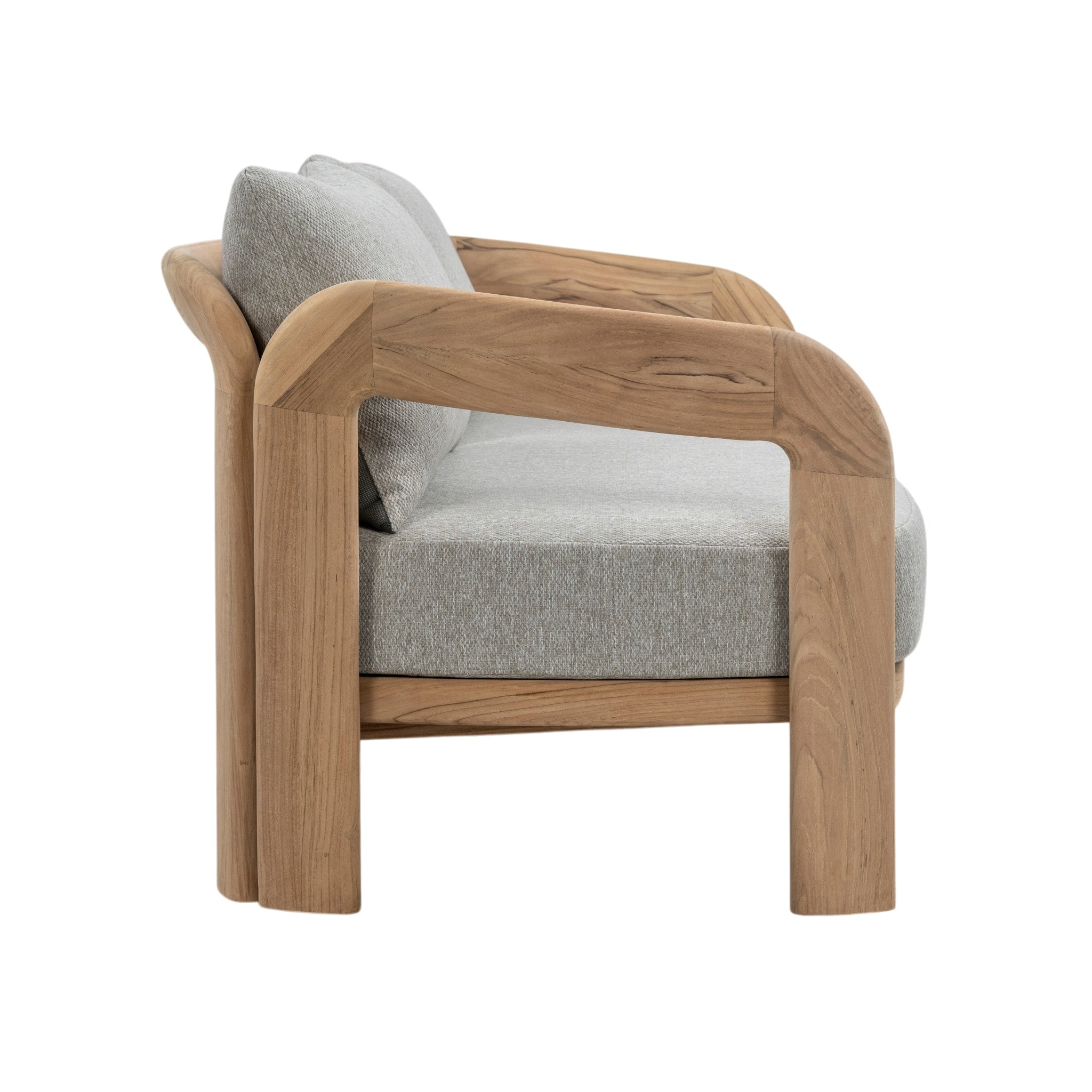 Side view of Caribbean outdoor teak sofa showing solid timber construction, curved armrest and padded grey cushions