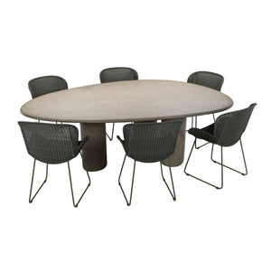 Curve outdoor concrete dining table surrounded by six dining chairs with an elliptical table top and three legs