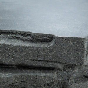 Fred outdoor coffee table closeup to show jagged edges and flat top. Made of fibrestone with unique trapezoid look.