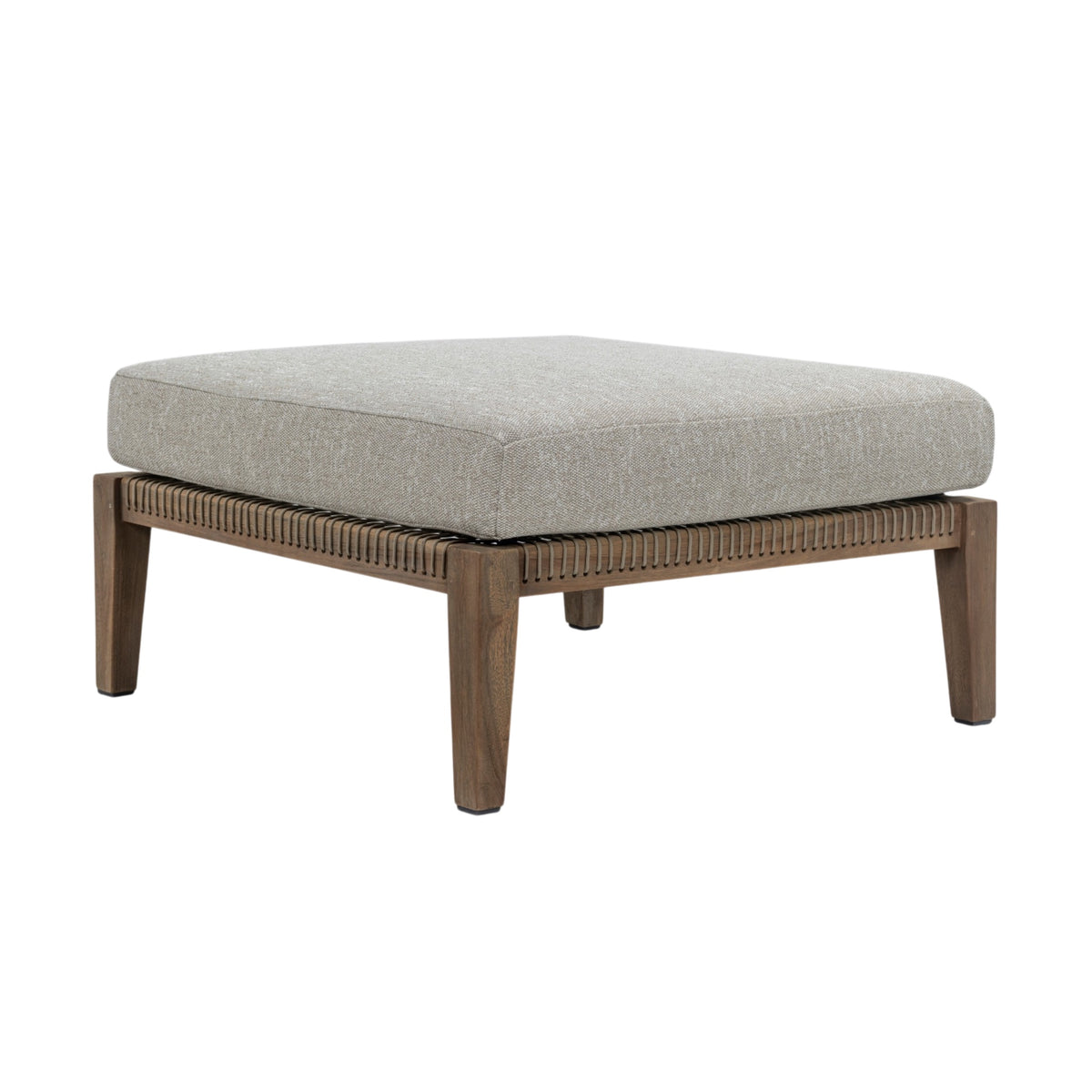 A square ottoman with a thick, light gray textured fabric cushion and a medium brown wooden frame with a fluted front apron and tapered legs, shown on a plain white background.