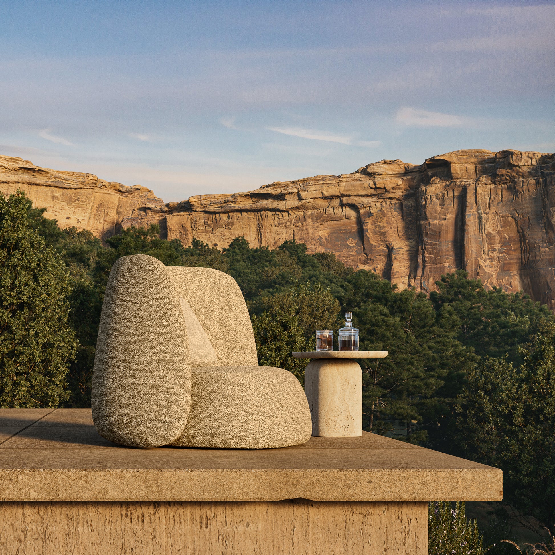 Monaco high back lounge chair situated outdoors with a wooded canyon as backdrop.