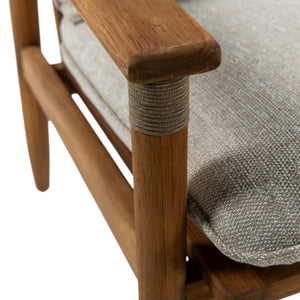 Close-up of a wooden armchair corner showing a medium brown wood frame, rope-wrapped post, and a light gray textured fabric cushion.
