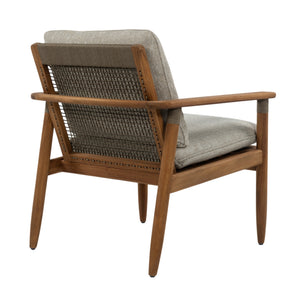 A mid-century modern accent chair with a warm medium-brown wooden frame, woven cane backrest, and light beige textured fabric cushions, shown from a three-quarters angle on a white background.