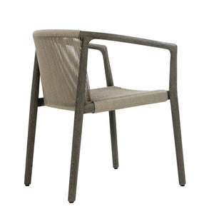 Rear angled view of Palma teak outdoor dining armchair showing weathered timber frame and woven rope backrest
