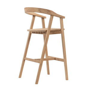 A light natural oak wood bar stool with a curved backrest, seat, and footrest, shown from a three-quarter angle on a solid white background.