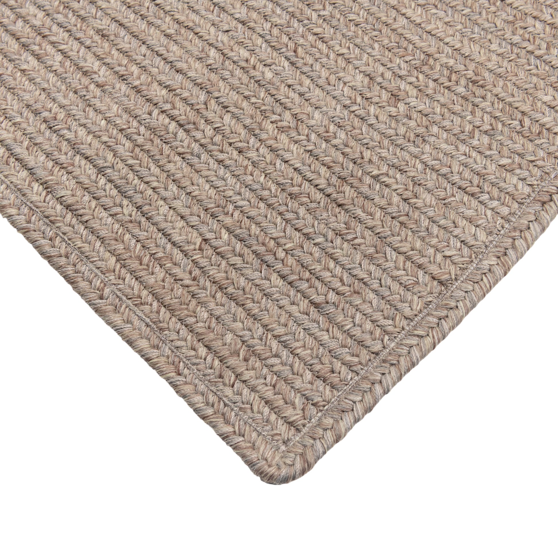 Close-up of a textured beige rug corner on a white background