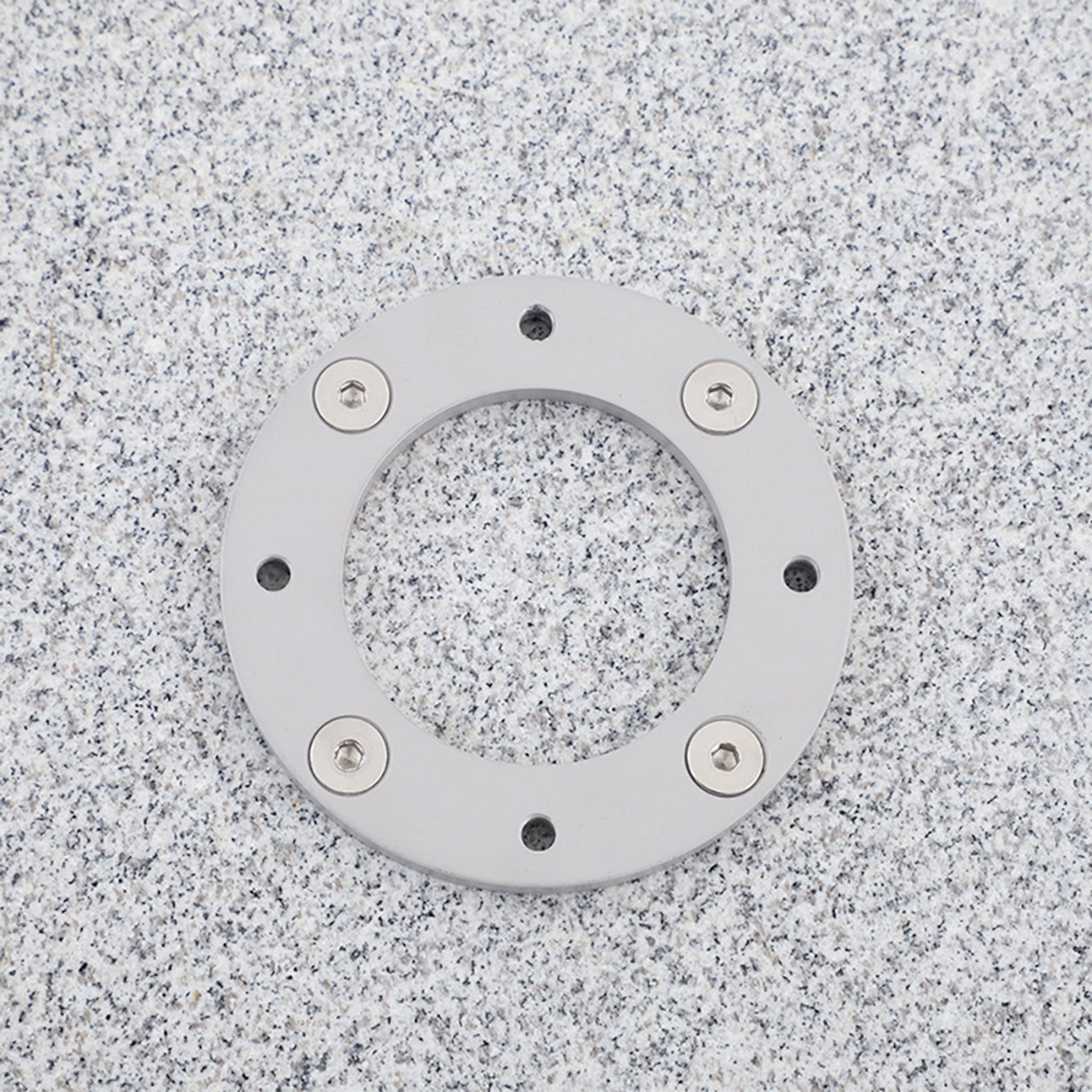 Closeup of square granite stone umbrella base with wheels for cantilever umbrellas. 