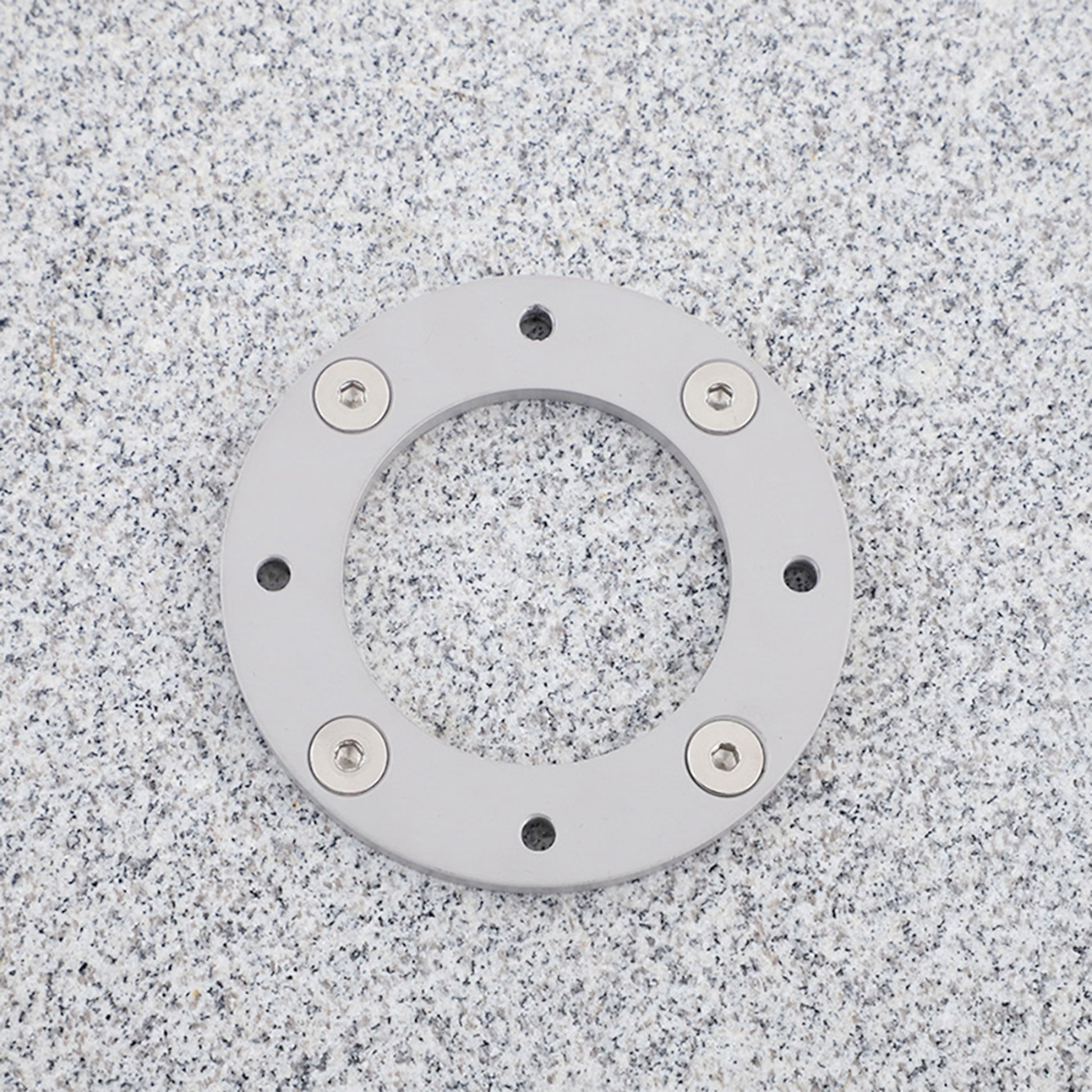 Closeup of square granite stone umbrella base with wheels for cantilever umbrellas. 