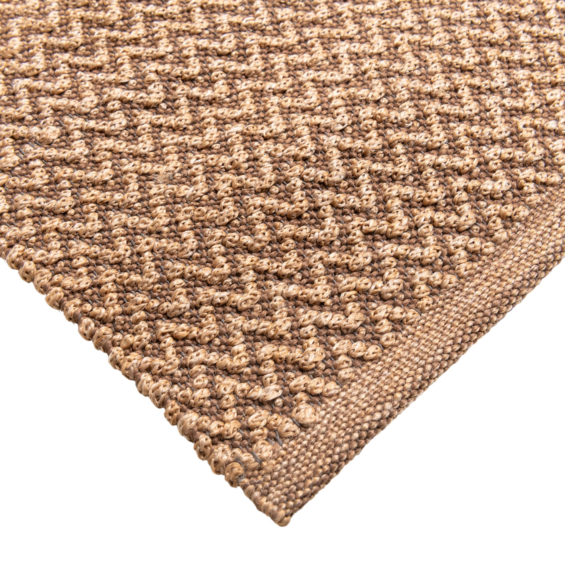 Closeup of Sundara outdoor floor rug corner. Showing handwoven details and edges.