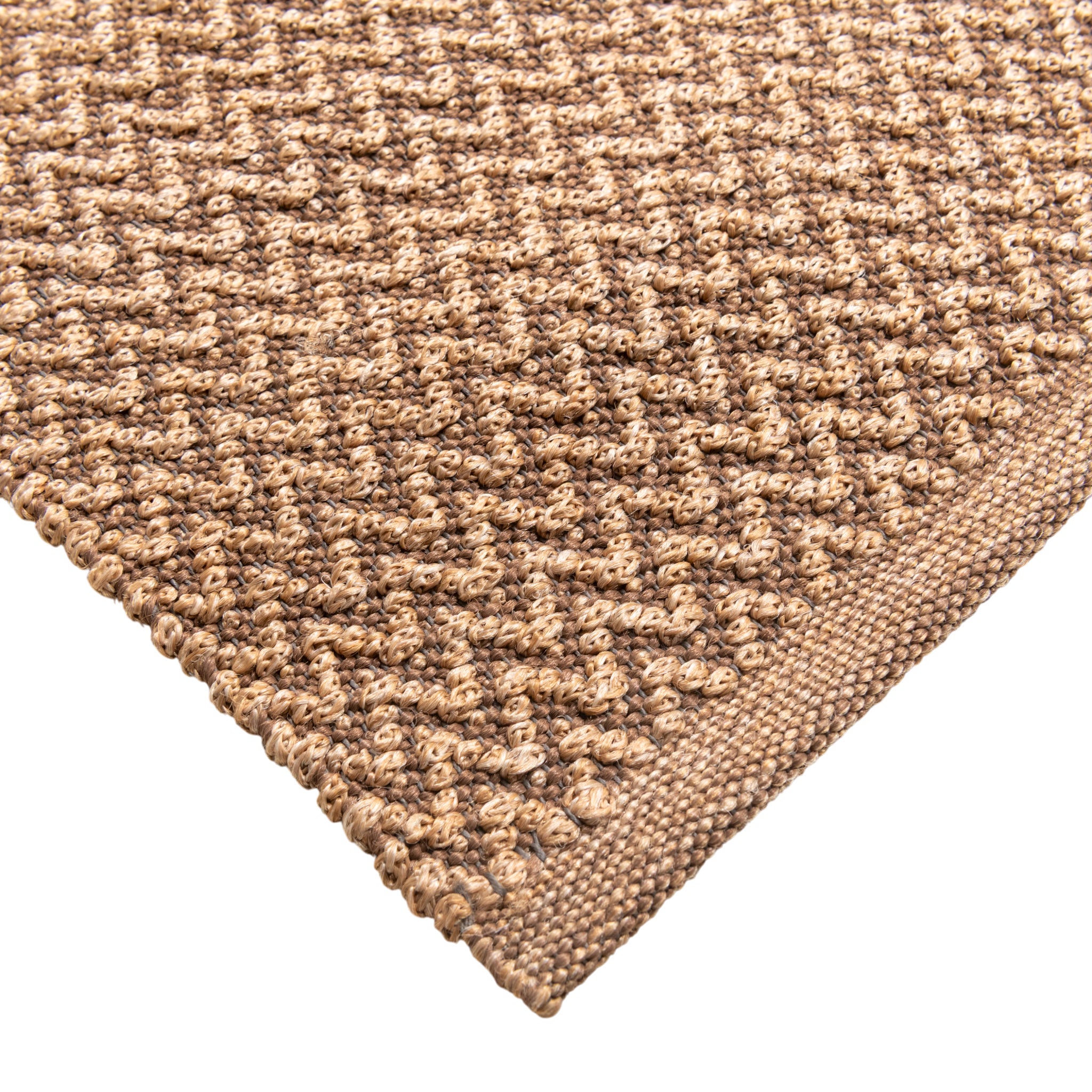 Closeup of Sundara outdoor floor rug corner. Showing handwoven details and edges.
