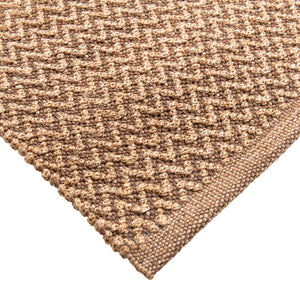 Closeup of Sundara outdoor floor rug corner. Showing handwoven details and edges.