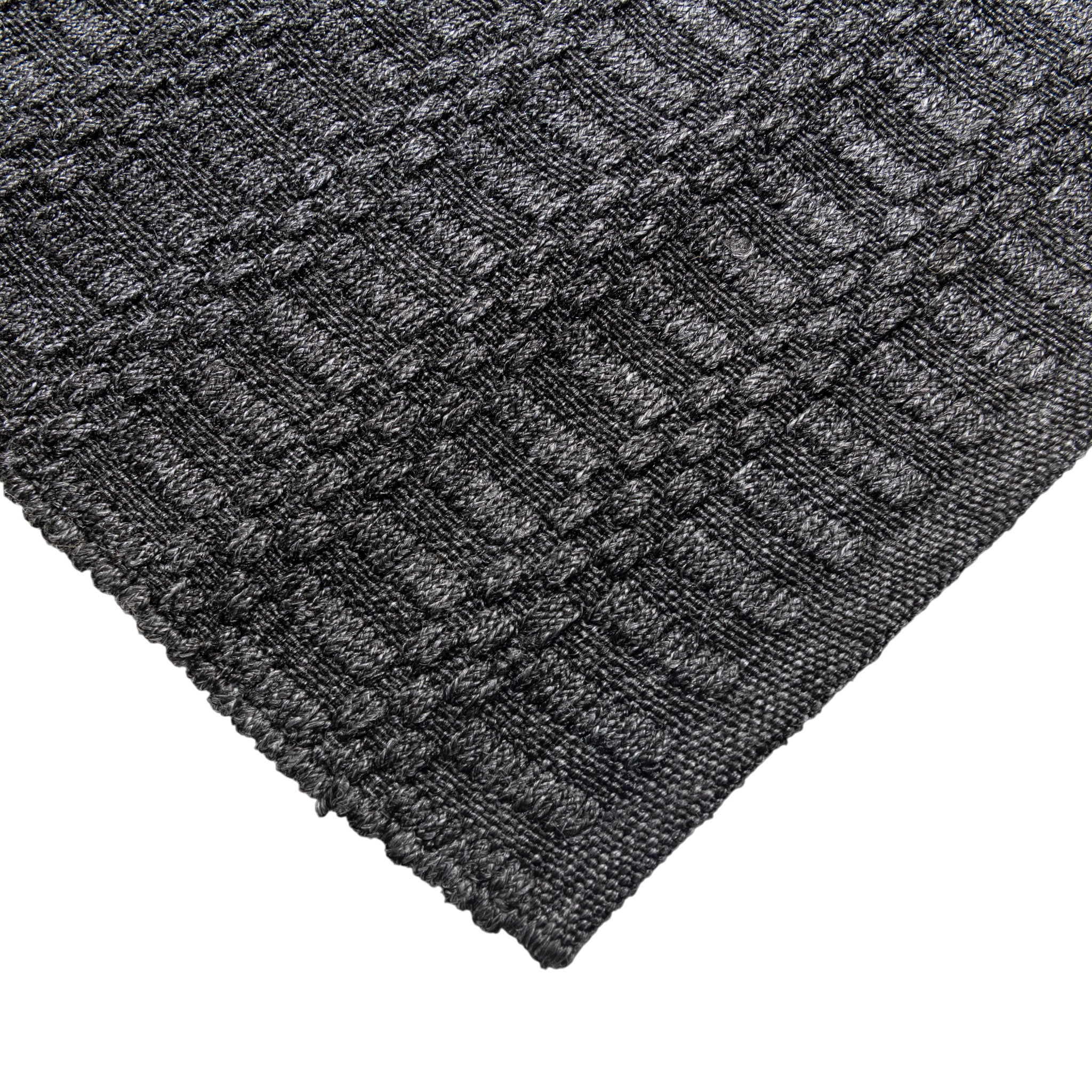 Close-up of a textured dark gray rug with a geometric pattern on a white background