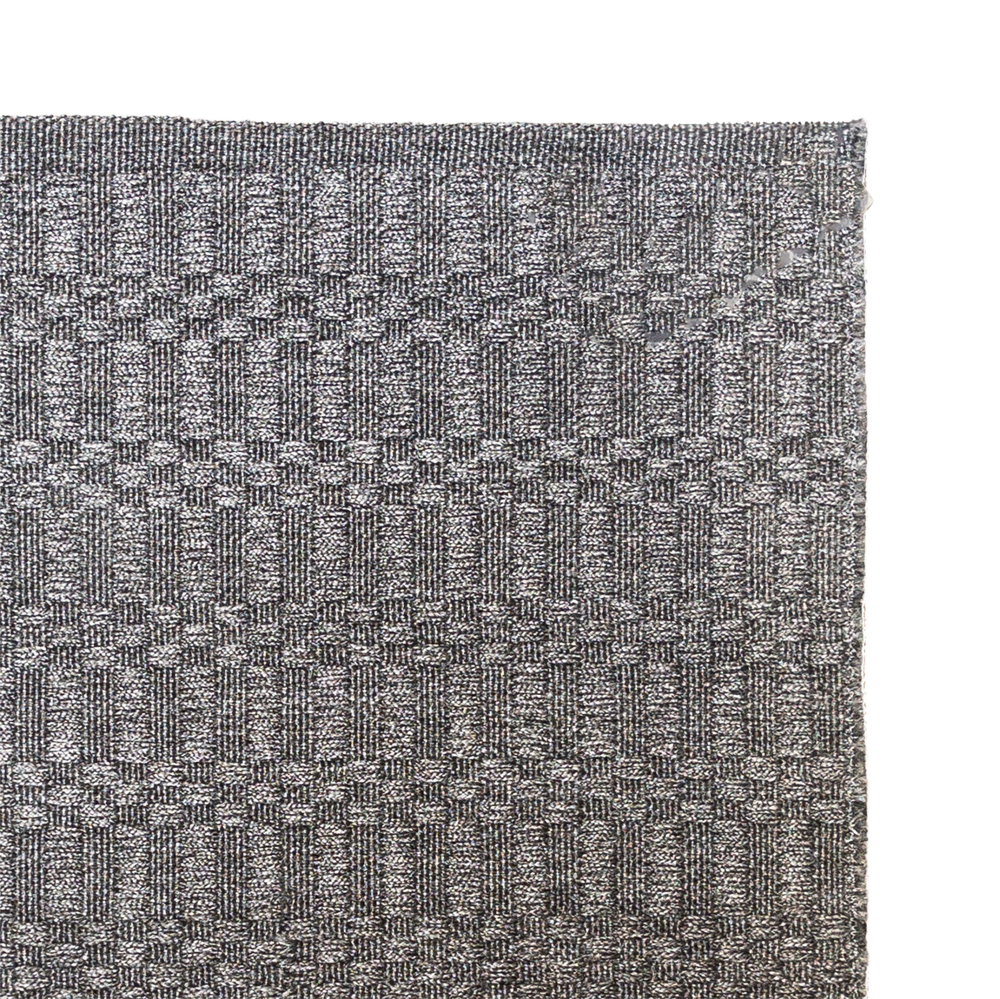 Close-up of a textured gray rug with a geometric pattern on a white background
