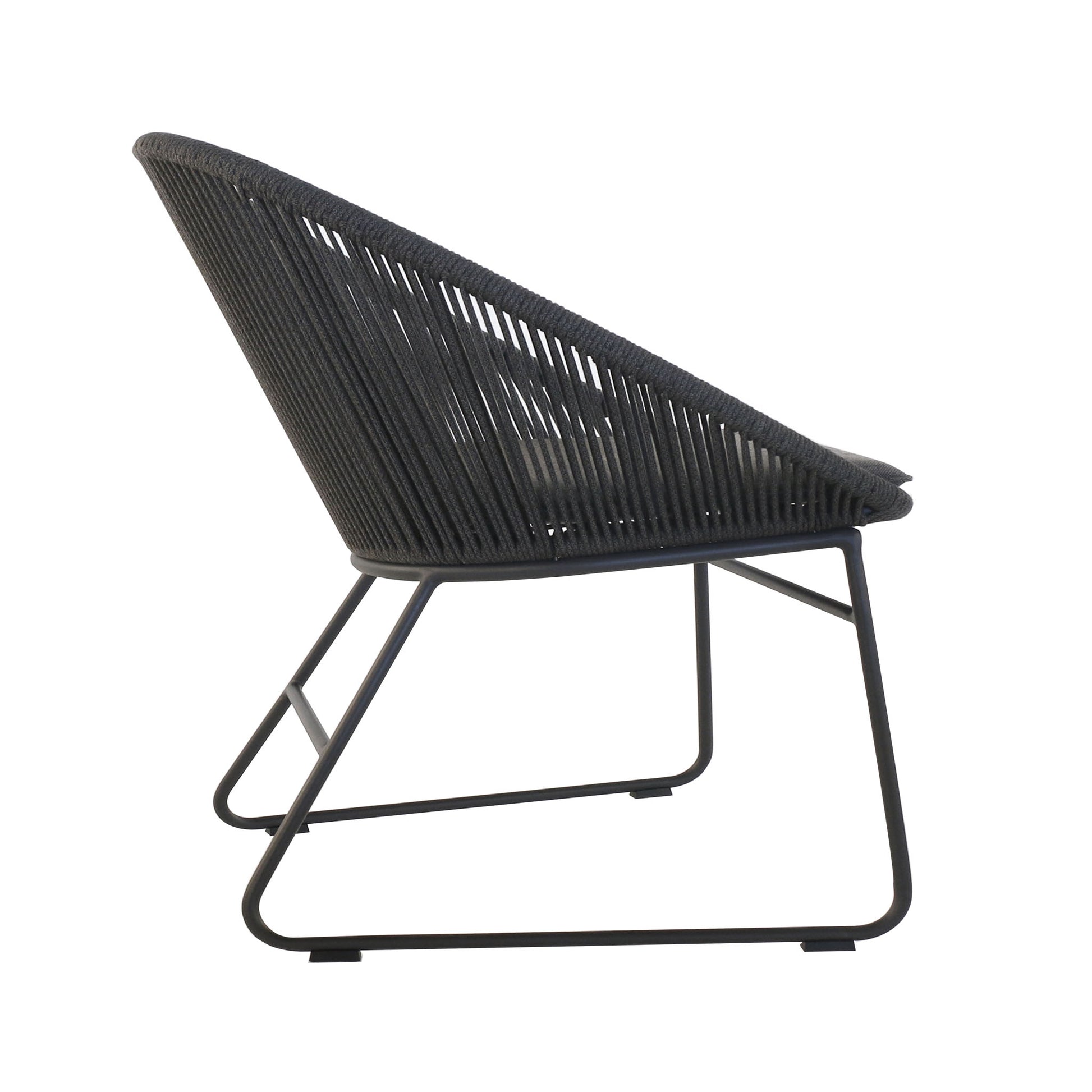 Side view of outdoor dining chair with airy woven rope wrapped around a curved aluminium frame with a white backdrop.