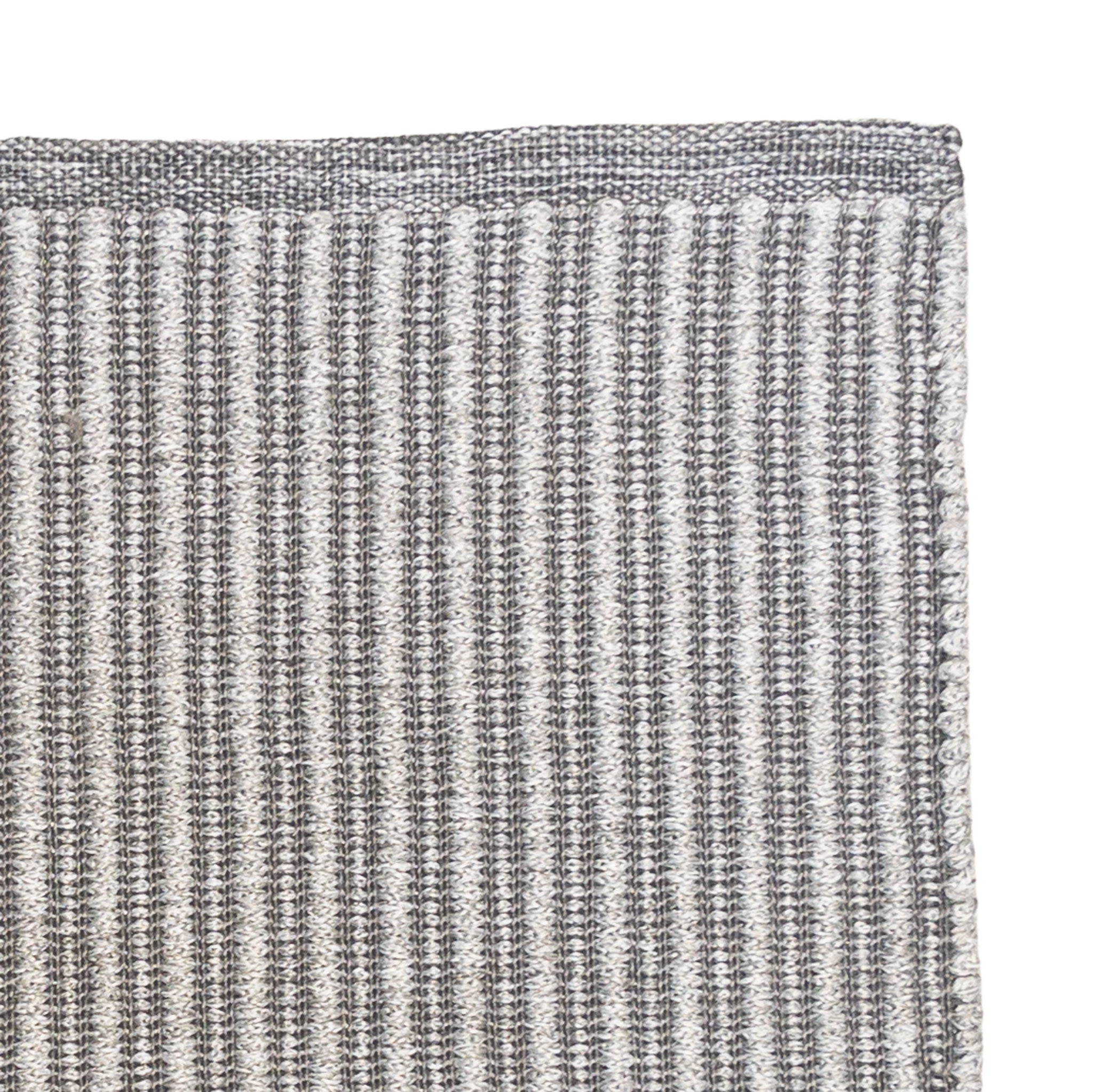 Close-up of a textured gray rug corner on a white background